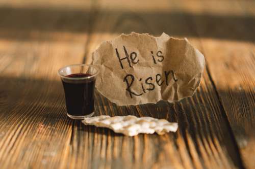 Communion. Religious tradition of breaking bread. Bread and wine as a sign of memory of Christ's sacrifice.